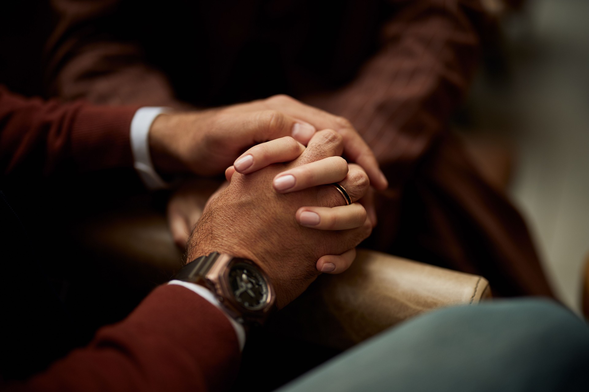 Close-Up of Hands Clasped Together in a Gesture of Comfort and Support