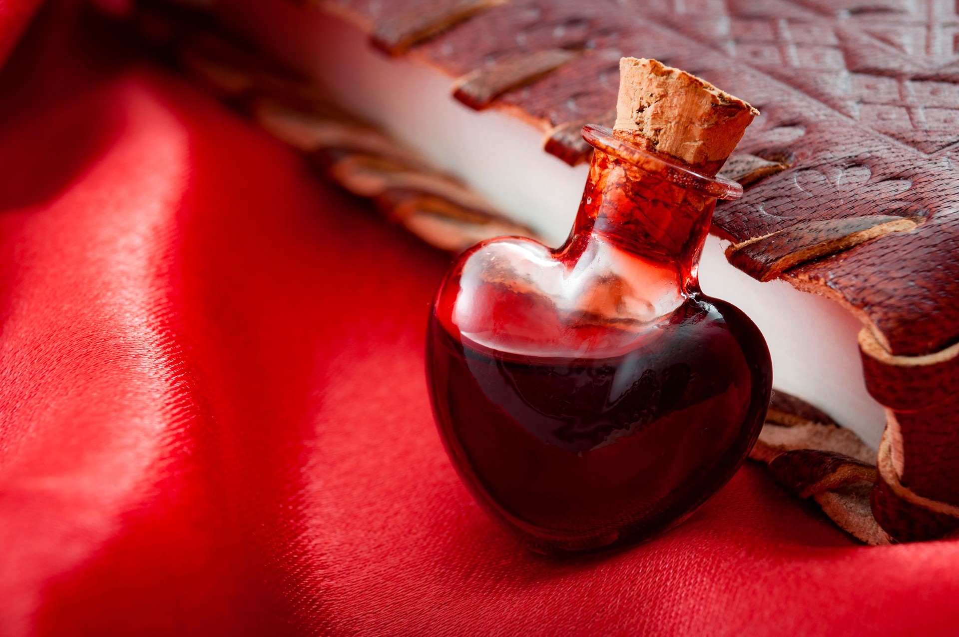 Love potion leaning on a book of spells