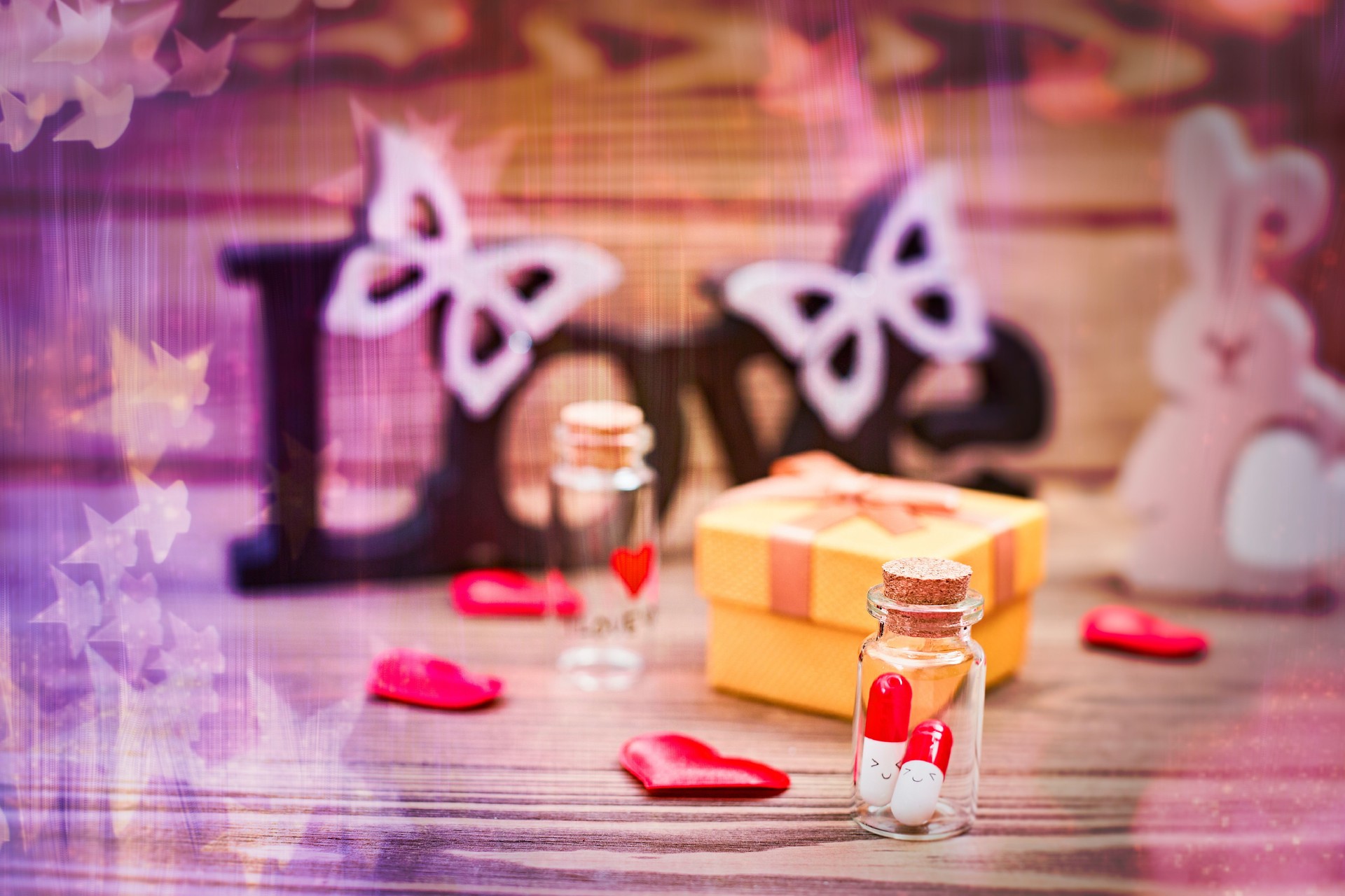 Valentine's Day  Wooden table against defocused lights.  Love medicine. I love you .Tablets in jars are kissing,
